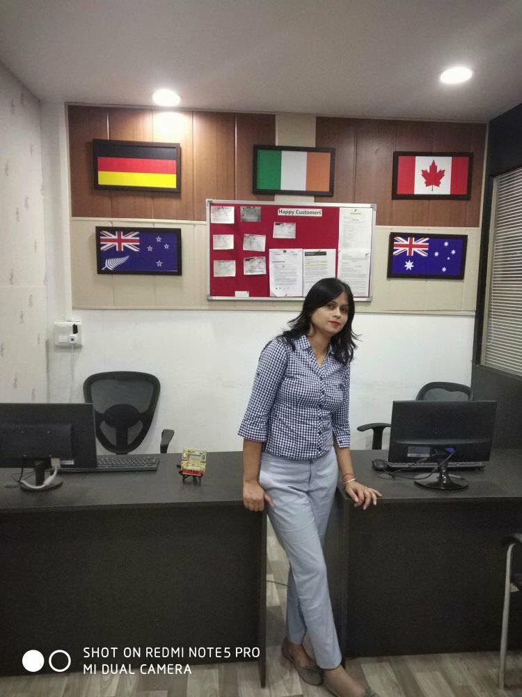 Ms. Navneet Sharma in her IELTS classroom with international flags